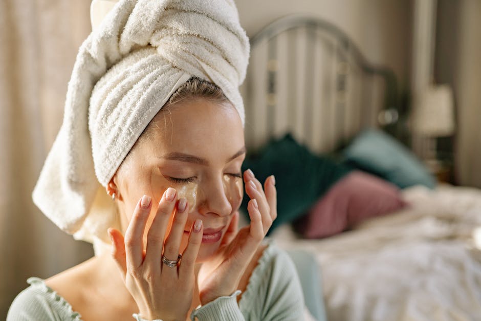 Woman enjoying a skincare routine with an under eye mask in a cozy bedroom setting