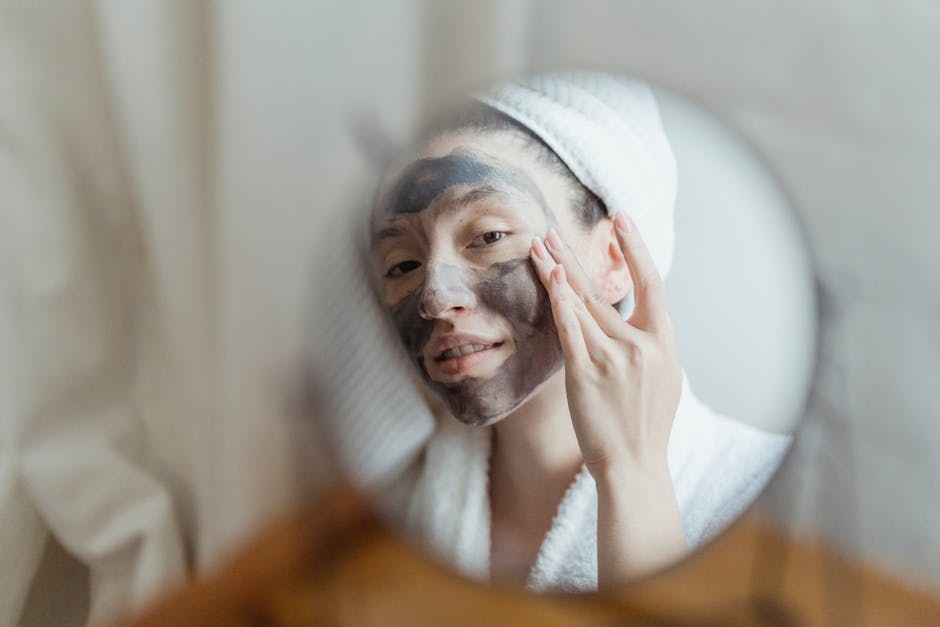 A woman enjoying a beauty routine with a face mask in an indoor setting