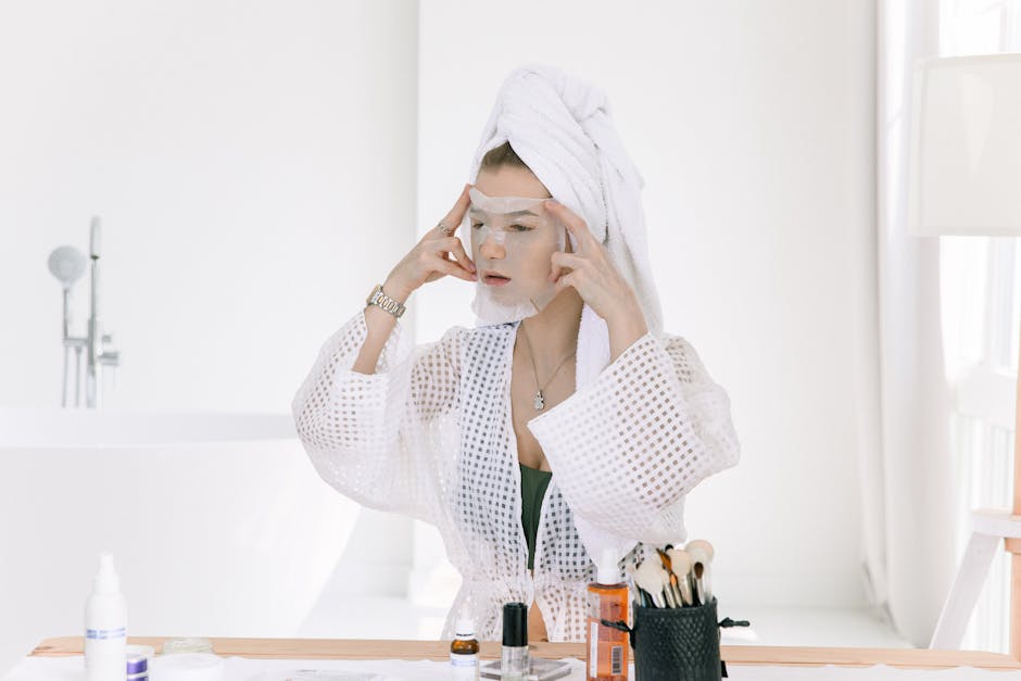 Woman applying a face mask in a bathroom, focusing on skincare and relaxation