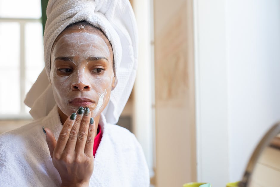 Woman applying face cream in bathroom, part of her daily skincare routine